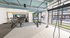 Modern fitness center with state-of-the-art gym equipment and large windows offering natural light.