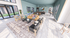 Elegant open-concept living space with modern decor, featuring large windows, stylish furnishings, and a sleek kitchen area.
