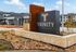 Inviting entrance sign for Trinity Estancia with modern architectural design and landscaped surroundings.