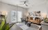 Chic and modern living room with a stylish brown leather sofa, abstract wall art, and elegant lighting, creating a warm and inviting atmosphere.