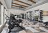 Modern gym with state-of-the-art equipment, featuring exercise bikes, weight racks, and stylish geometric flooring, perfect for an invigorating workout session.