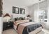 Cozy bedroom with elegant decor, featuring a plush bed, stylish bedside lamps, and a large window inviting natural light.