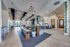Elegant open-concept living area featuring stylish furniture, modern lighting, and ample natural light through large windows.