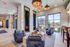 Chic apartment lounge with plush seating, modern decor, and floor-to-ceiling windows offering abundant natural light.