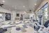 Modern and spacious gym with state-of-the-art equipment, colorful geometric carpet, and ample natural light.