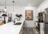 Contemporary kitchen with sleek white countertops, modern appliances, and vibrant artwork, exuding a stylish and inviting ambiance.