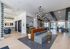 Contemporary apartment lobby with modern lighting, stylish seating, and an open-concept design featuring large windows and vibrant decor.
