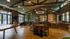 Spacious and elegant communal area featuring wooden flooring, modern furniture, and abundant natural light, perfect for social gatherings.