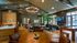 Elegant lounge area with modern seating, vibrant greenery, and ambient lighting, perfect for relaxation and gatherings.