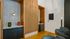 Contemporary apartment bar area with sleek cabinetry, stylish lighting, and modern decor accents.