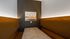 Cozy alcove seating with warm lighting and a stylish art piece, perfect for intimate gatherings.