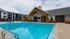 Luxurious apartment community offering a sparkling swimming pool with stylish lounge chairs, modern clubhouse, and elegant architectural design.