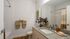 Elegant bathroom with granite countertop, stylish decor, and inviting warm tones for a relaxing atmosphere.