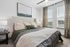 Bright, modern bedroom with elegant decor, plush bedding, and large windows offering serene views.