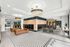 Modern apartment lobby with stylish lighting, comfortable leather seating, and chic patterned flooring, featuring a convenient mail center and cozy seating area.