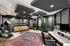 Luxurious home recording studio featuring modern acoustic panels, a stylish couch, state-of-the-art audio equipment, and a contemporary design with warm lighting.