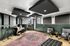 Modern apartment interior with a stylish recording studio setup, chic seating, and elegant acoustic panels.