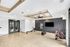 Modern and spacious fitness room featuring sleek wooden floors and contemporary exercise equipment, perfect for an active lifestyle.