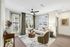 Sophisticated living room with plush seating, modern decor, and large windows inviting natural light.