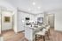 Modern kitchen with sleek white cabinetry, featuring a cozy breakfast bar and stainless steel appliances. Perfect blend of functionality and style.