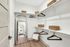 Elegant walk-in closet with ample storage, featuring sleek wooden hangers, woven baskets, and a stylish full-length mirror.