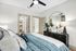 Elegant bedroom showcasing a plush bed, stylish decor, and walk-in closet, all bathed in natural light.