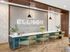 Elegant reception area with modern chandeliers, stylish green chairs, and a welcoming atmosphere at Ellison Cool Springs.