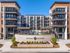 Modern apartment complex featuring stylish balconies, central pool, and inviting outdoor spaces at District Eastside.