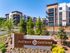 Modern apartment complex District Eastside with lush landscaping, offering stylish living spaces and contemporary architecture.
