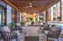 Chic outdoor lounge area with modern seating and stylish pergola, overlooking a sparkling pool.