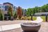 Modern apartment exterior featuring stylish architecture, landscaped pathways, and a cozy outdoor fire pit area.