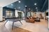 Chic and modern communal lounge featuring a stylish ping pong table and cozy seating area, ideal for socializing and relaxation.