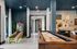Modern lounge area featuring a stylish shuffleboard table, vibrant skee-ball game, and chic wall art for an inviting atmosphere.