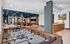 Modern recreation room featuring a foosball table, arcade game, and stylish lounge with contemporary decor.