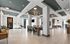 Modern and spacious community room with stylish furnishings, featuring ample seating, high ceilings, and elegant lighting.