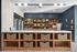 Contemporary apartment amenity space with a sleek snack display, stylish shelving, and woven storage baskets.