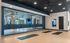 Modern fitness studio with mirrored walls, exercise mats, and a sleek design, perfect for yoga and barre classes.