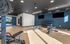 Modern gym with sleek equipment and ample natural light, perfect for energetic workouts and fitness enthusiasts.