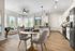 Bright and modern open-concept apartment featuring a sleek kitchen, stylish dining area, and cozy living space with natural light.