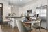 Modern kitchen with sleek stainless steel appliances, elegant countertops, and cozy dining area for a stylish culinary experience.