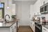 Modern kitchen with sleek cabinets, polished countertops, and stainless steel appliances, perfect for culinary enthusiasts.