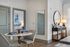 Chic apartment interior with an elegant dining area and a view into a cozy, well-lit bedroom.