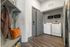 Contemporary laundry area featuring sleek appliances, elegant storage solutions, and warm decor accents for a stylish touch.