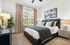 Inviting bedroom with elegant decor, plush bedding, and a large window for natural light, creating a serene retreat.