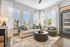 Bright and welcoming living room with large windows, stylish furnishings, and a cozy seating area.