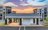 Chic modern apartments with stylish exterior, promising scenic views and vibrant sunsets.