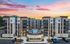 Modern apartment complex at sunset featuring a central swimming pool, elegant architecture, and landscaped surroundings.