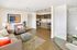 Modern open-concept living room with elegant kitchen, cozy seating area, and stylish decor.