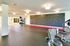 Bright and modern fitness room featuring a state-of-the-art climbing wall, exercise equipment, and ample space for workouts.