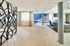 Bright and spacious contemporary living area with elegant décor, featuring stylish partition, large windows, and modern furnishings.